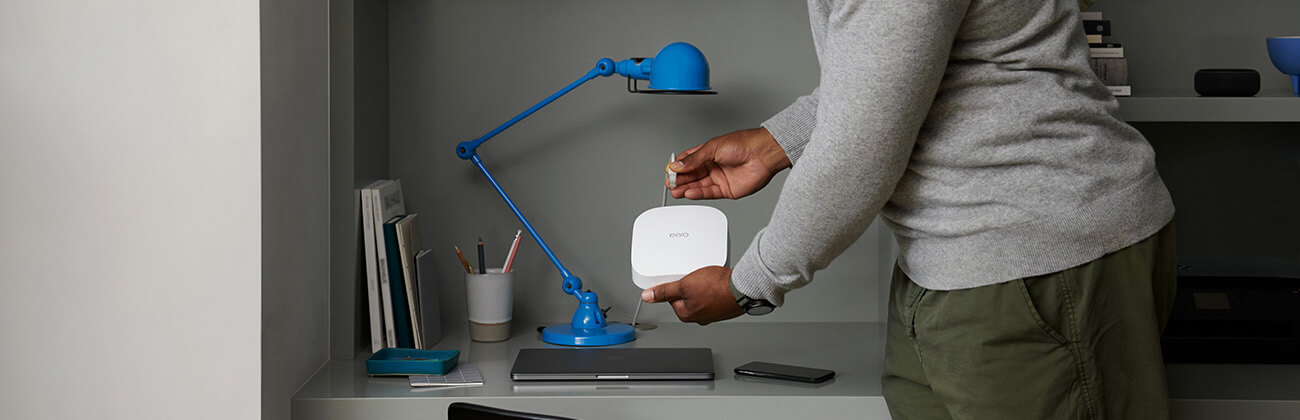 African American male plugging in a eero device