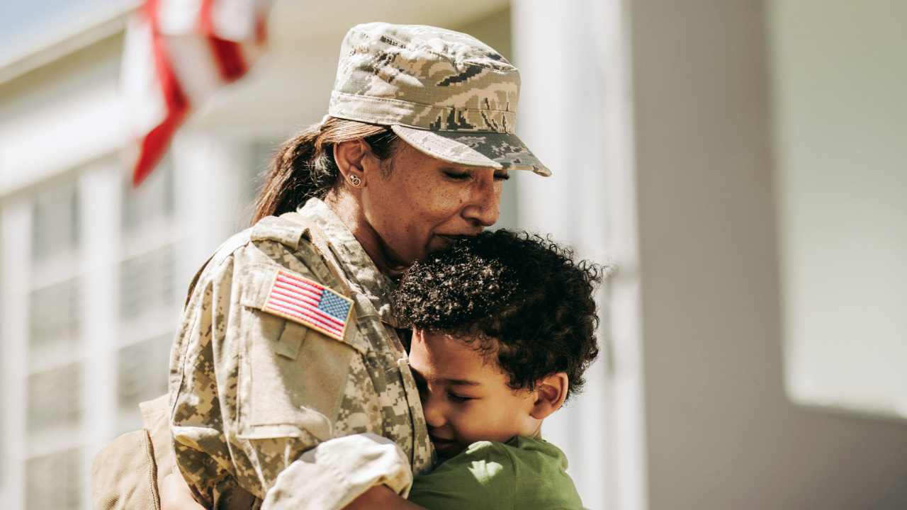 Young son hugs his military attired Mom on Veteran’s Day (November 11)