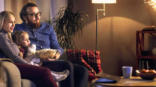 young family on the sofa watches streaming TV